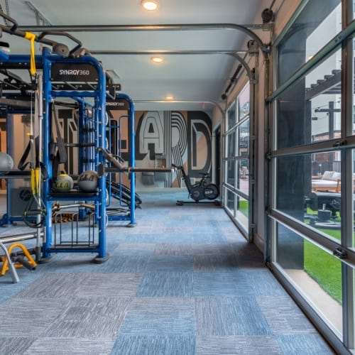 gym interior at apartments in Burleson TX with weights and cardio equipment